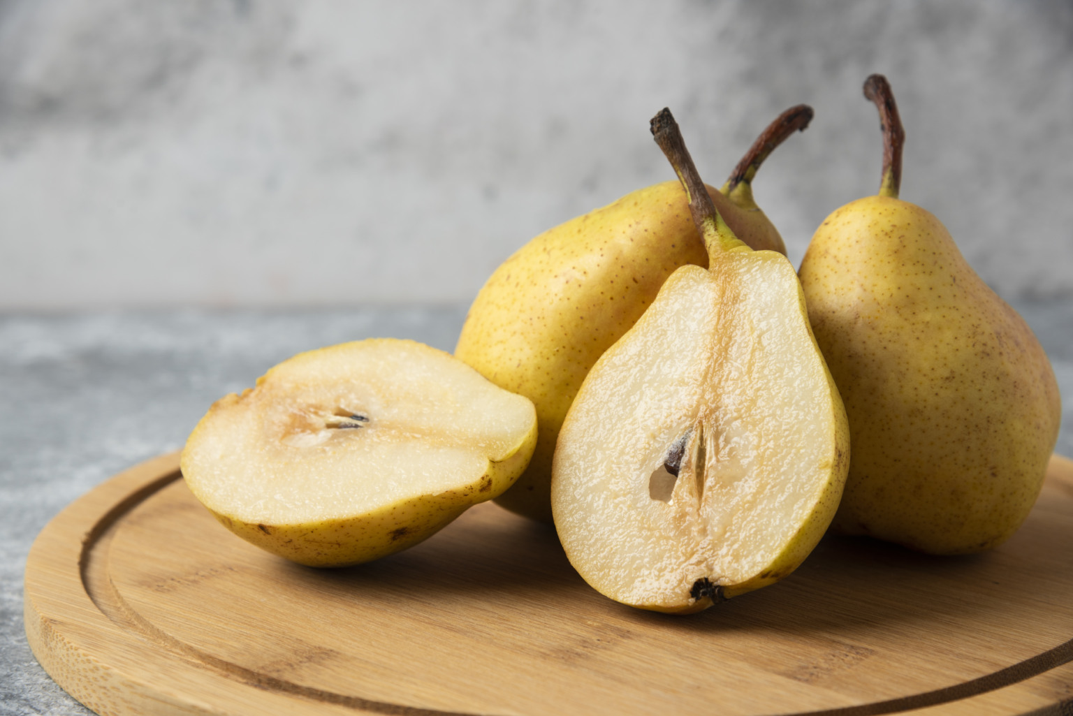 Green pears on a wooden board. High quality photo