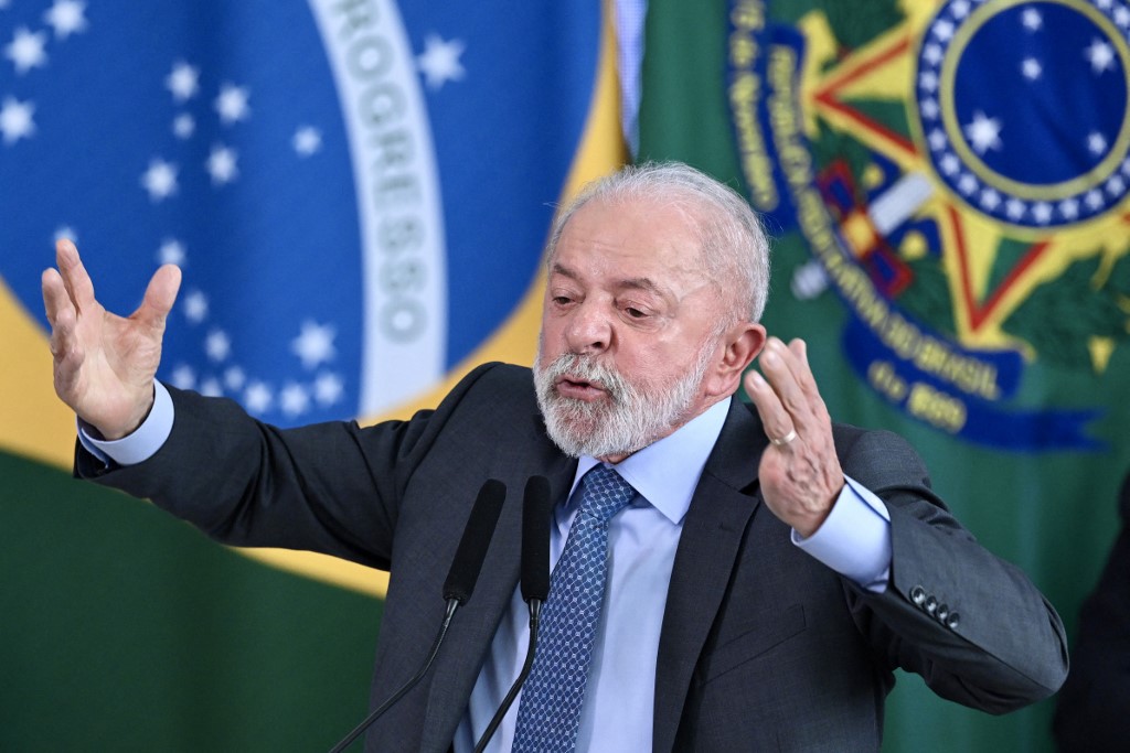 Brazil's President Luiz Inacio Lula da Silva gestures as he speaks during the signing ceremony of the new Income Tax Law at the Planalto Palace in Brasilia. on November 26, 2025. (Photo by Evaristo Sa / AFP)